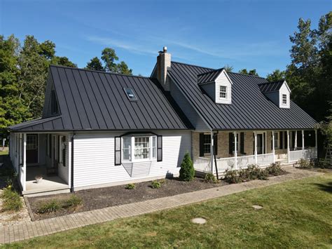 white brick house with black metal roof|brick house metal roof pictures.